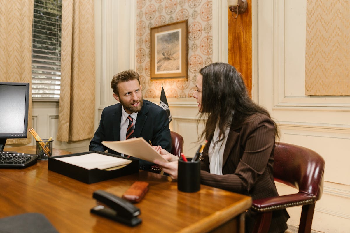 Legal professionals discussing documents during intake handoff